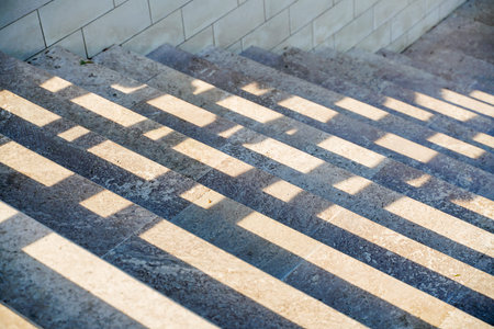 Staircase in the city, black and white pattern on the stairs on a sunny day.