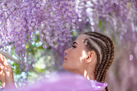 Woman wisteria lilac dress. Thoughtful happy mature woman in purの写真素材