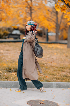 A woman walks outdoors in autumn, enjoys the autumn weather.の写真素材
