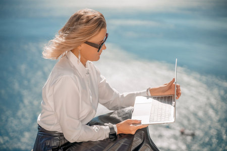 Business woman on nature in white shirt and black skirt. She wor