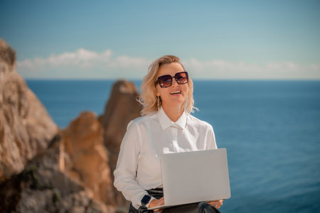 Business woman on nature in white shirt and black skirt. She worの写真素材