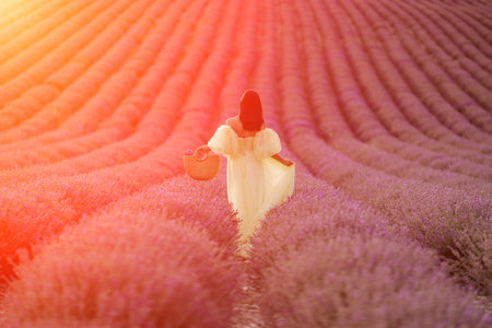 Lavender field happy woman in yellow dress in lavender field summer time at sunsetの写真素材