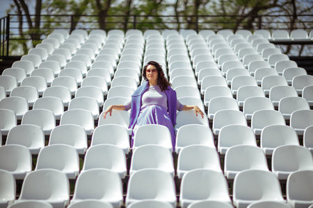 Woman Seats of tribune on sport stadium. Concept of fans, chairs for audience, cultural environment concept. mpty seats, modern stadium.の写真素材