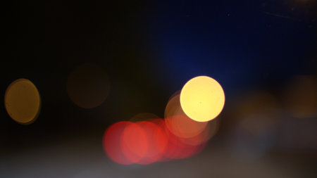 Blurred lights evening city traffic bokeh. Defocused night city traffic. Blurred lights bokeh car headlights driving evening city road. City night traffic backgroundの写真素材