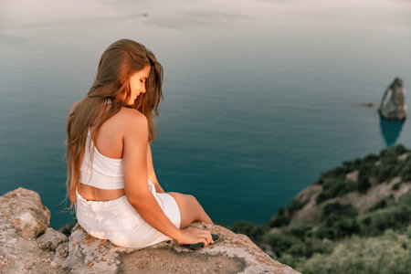 Portrait of a happy woman in a cap with long hair against the seaの写真素材