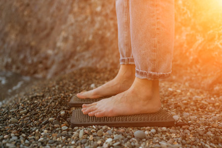 Sea Woman feet stepping on sadhu board during indian practice on the seashore. . Healthy lifestyle concept. tool for working out your inner stateの写真素材