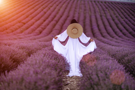 Woman lavender field. Lavender field happy woman in white dress in lavender field summer time at sunsetの写真素材