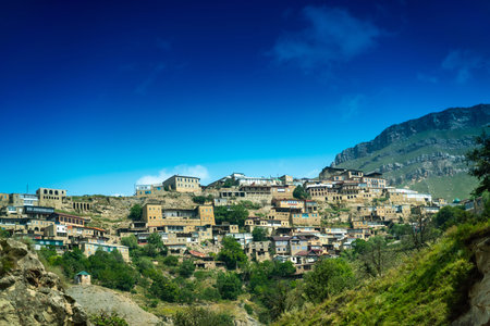 Village of Chokh in Dagestan. Facades of houses located in tiers on a steep slope, summer landscape.
