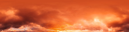 Dramatic sunset sky panorama with bright glowing red pink Cumulus clouds. HDR 360 seamless spherical...