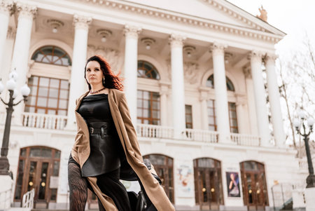 Woman street lifestyle. Image of stylish woman walking through European city on sunny day. Pretty...