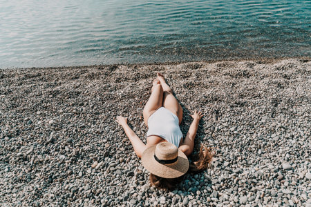 Woman white bikini beach tan. Happy woman in swimwear and hat on vacation. Summer travel holidays vacation on the seaの写真素材