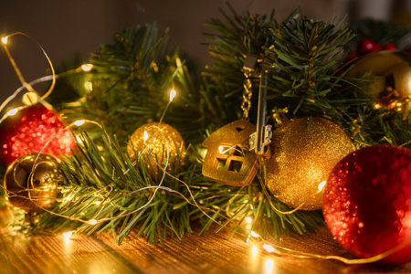 Gift key house with a keychain backdrop of Christmas tree. Building, design, project, moving to new...