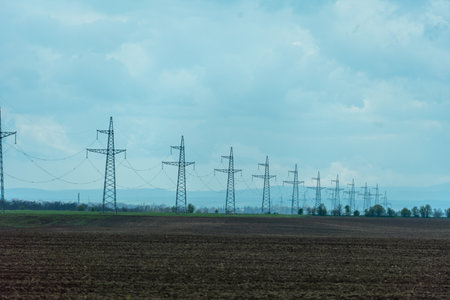 High voltage towers with sky background. Power line support with wires for electricity transmission. High voltage grid tower with wire cable at distribution station. Energy industry, energy savingの写真素材