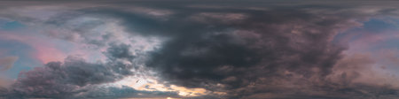 Dramatic sunset sky panorama with bright glowing red pink Cumulus clouds. HDR 360 seamless spherical...