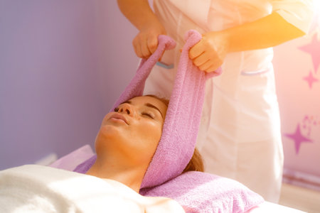 Relaxing massage. European woman getting head massage in spa salon, side viewの写真素材