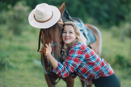 Happy blonde with horse in forest. Woman and a horse walking through the field during the day....
