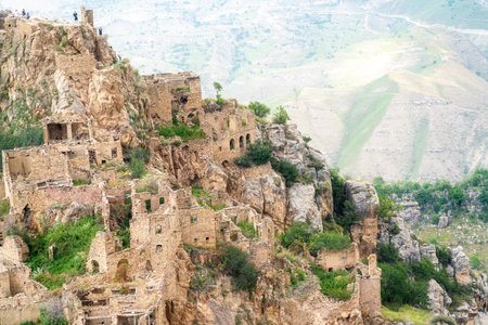 Dagestan Gamsutl. Ancient ghost town of Gamsutl old stone houses in abandoned Gamsutl mountain village in Dagestan, Abandoned etnic aul, summer landscape.の写真素材