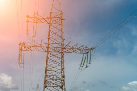 High voltage towers with sky background. Power line support with wires for electricity transmission. High voltage grid tower with wire cable at distribution station. Energy industry, energy savingの写真素材