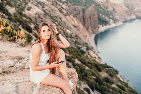 Portrait of a happy woman with long hair against the seaの写真素材
