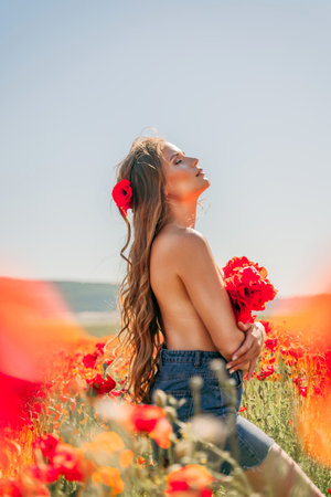 Woman poppies field. portrait happy woman with long hair in a poppy field and enjoying the beauty of nature in a warm summer day.の写真素材