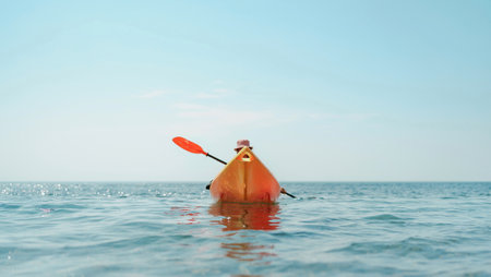Kayak sea woman. Happy attractive woman with long hair in red swimsuit, swimming on kayak. Summer holiday vacation and travel concept.の写真素材