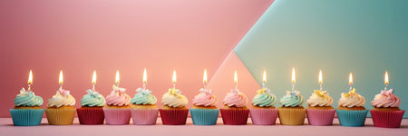 Colorful cupcakes with lit candles are displayed against a pink background, indicating an indoor celebration event marking of joy and celebrating. with free spaceの素材