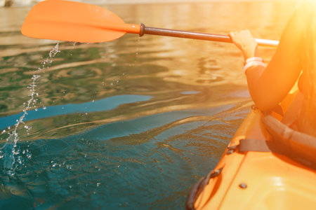 Kayak paddle sea vacation. Person paddles with orange paddle oar on kayak in sea. Leisure active lifestyle recreation activity rest tourism travelの写真素材