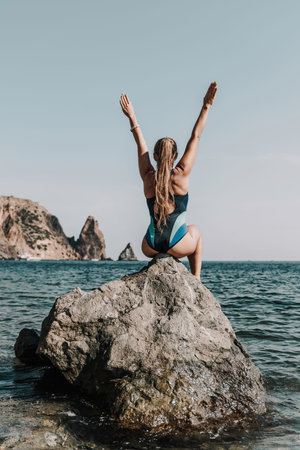 Woman beach vacation photo. A happy tourist in a blue bikini enjoying the scenic view of the sea and...