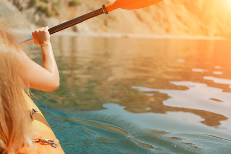 Kayak paddle sea vacation. Person paddles with orange paddle oar on kayak in sea. Leisure active...