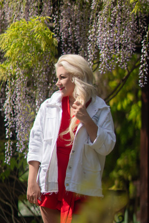 A blonde woman wearing a white jacketの写真素材