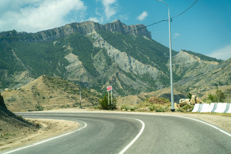 View from the car of an asphalt road in the mountainous area of Dagestanの写真素材
