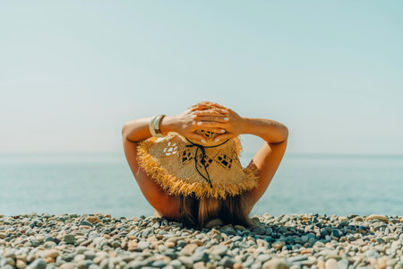 Beach Relaxation woman lies on a pebble beach. The concept of travel, vacation at seaの写真素材
