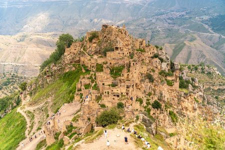 Dagestan Gamsutl. Ancient ghost town of Gamsutl old stone houses in abandoned Gamsutl mountain village in Dagestan, Abandoned etnic aul, summer landscape.の写真素材