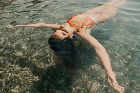 Happy woman sea relaxing floating in transparent sea water on summer holiday. Travel leisure recreation lifestyle, female in nature.の写真素材