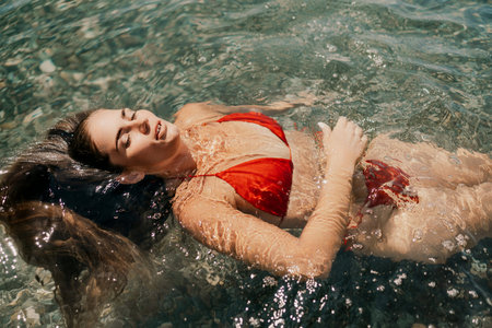 Happy woman sea relaxing floating in transparent sea water on summer holiday. Travel leisure...
