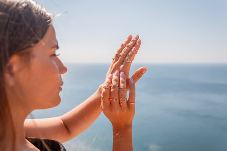 A woman with long hair is standing on a beachの写真素材