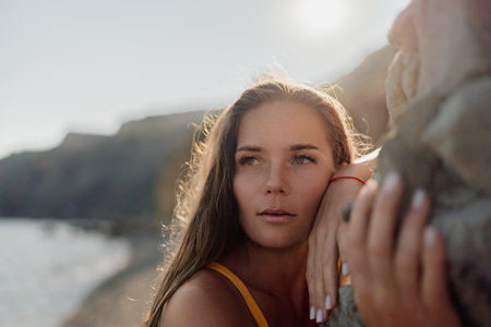 A woman with long hair is looking at the cameraの写真素材