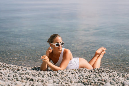 Freelance close up woman hands writing on computer. Well looking middle aged woman typing on laptop keyboard outdoors with beautiful sea view.の写真素材
