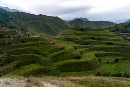 Chokhsky terraces Dagestan. Landscape of mountainous Dagestan with terraced fields and peaks mountains in the distance.の写真素材