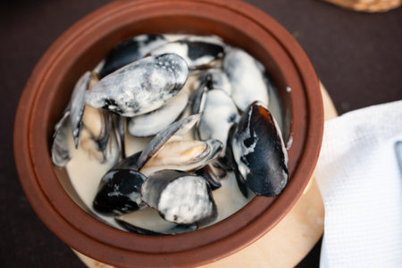 Mussels Cream Sauce Dish Food - Close-up of a dish of mussels in a creamy sauce in a clay pot.の写真素材