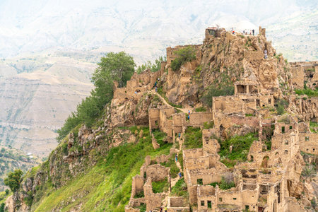 Dagestan Gamsutl. Ancient ghost town of Gamsutl old stone houses in abandoned Gamsutl mountain village in Dagestan, Abandoned etnic aul, summer landscape.の写真素材