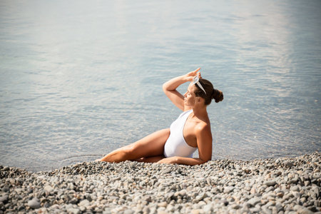 Freelance close up woman hands writing on computer. Well looking middle aged woman typing on laptop keyboard outdoors with beautiful sea view.の写真素材