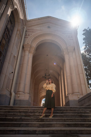 Woman, Architecture, Tbilisi - A woman stands on the steps of a grand building in Tbilisi, Georgia....