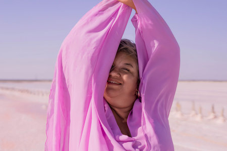 Woman Pink Shirt Smiling Outdoorsの写真素材