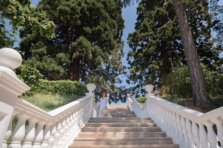 A woman is walking up a set of white stairs
