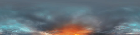 Dramatic Sunset sky 360 panorama. Vibrant sky with bright glowing red pink Cumulus clouds. HDR 360 seamless spherical panorama. Sky dome for aerial drone panoramas. Climate and weather change.の写真素材