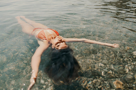 Happy woman sea relaxing floating in transparent sea water on summer holiday. Travel leisure...