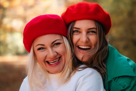 Women Red Berets Smiling Autumn Parkの写真素材