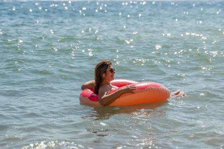 Woman, Inflatable Ring, Sea: Relaxing in the Ocean on a Sunny Day
