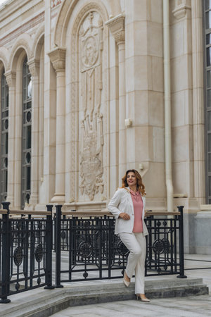 Woman White Suit Church Building Architecture Tbilisi, Georgia - A woman dressed in a white suit...